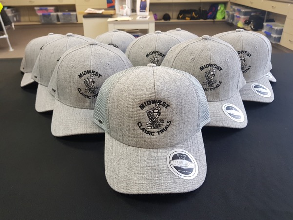 Grey trucker caps embroidered with a custom club logo