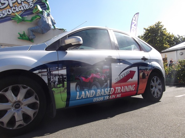 Ford hatchback wrapped with Land Based Training graphics and phone number