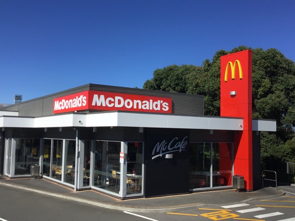 McDonald’s restaurant exterior with backlit fascia and totem signage
