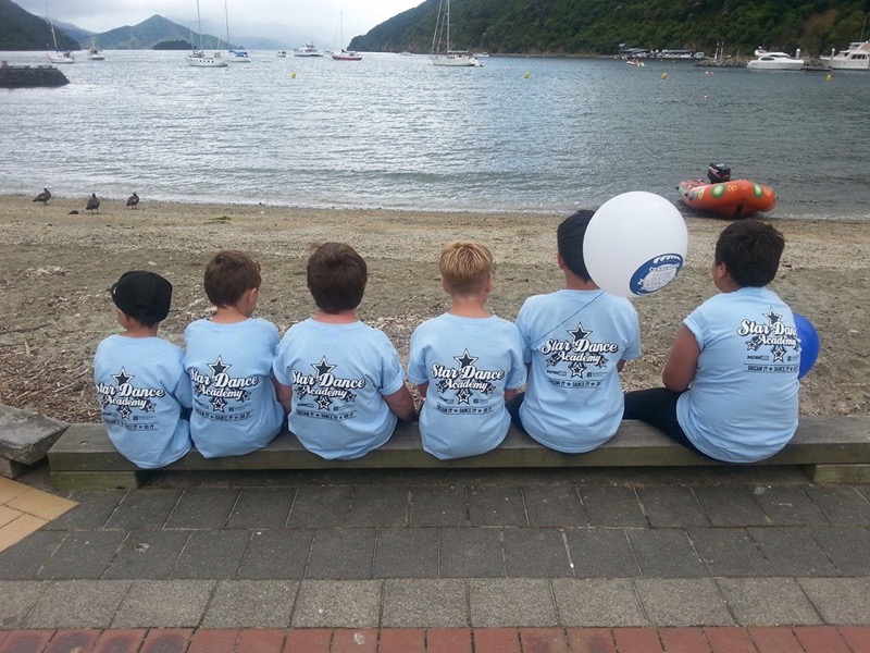 Children wearing pale blue Star Dance Academy printed T-shirts at the waterfront