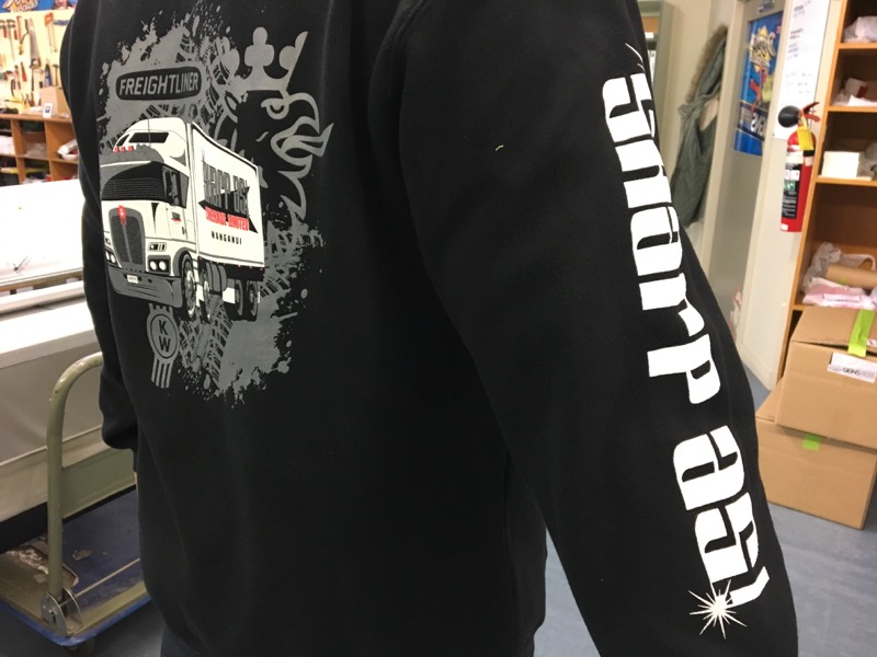 Black hoodie screen printed with Sharp As Transport truck artwork and sleeve branding